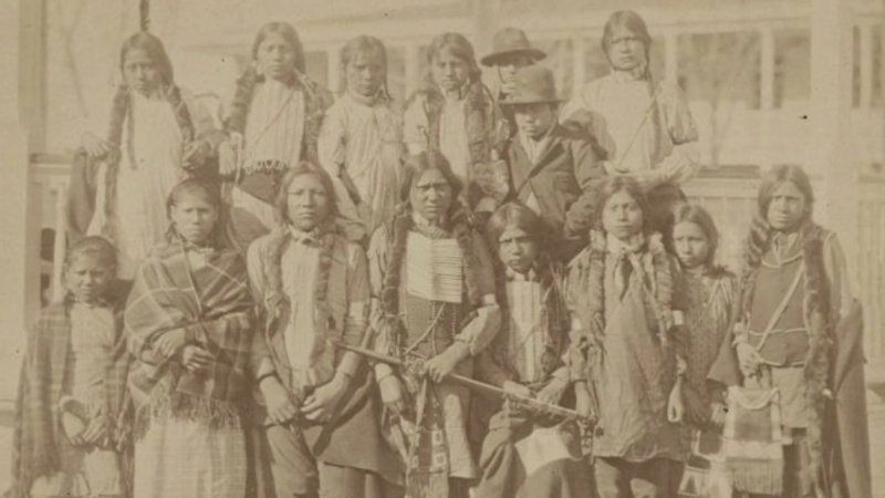 A group of Cheyenne women and children in traditional clothing photographed in the late 19th century