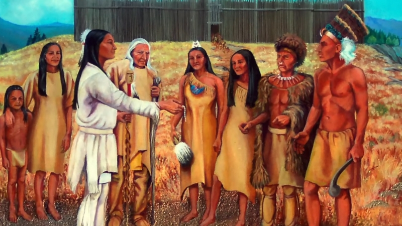 A painting shows the Iroquois men and women in traditional dress gathered outdoors