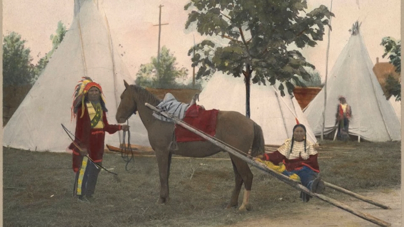 Sioux people with a horse and traditional tipi tents during their migration to the Great Plains
