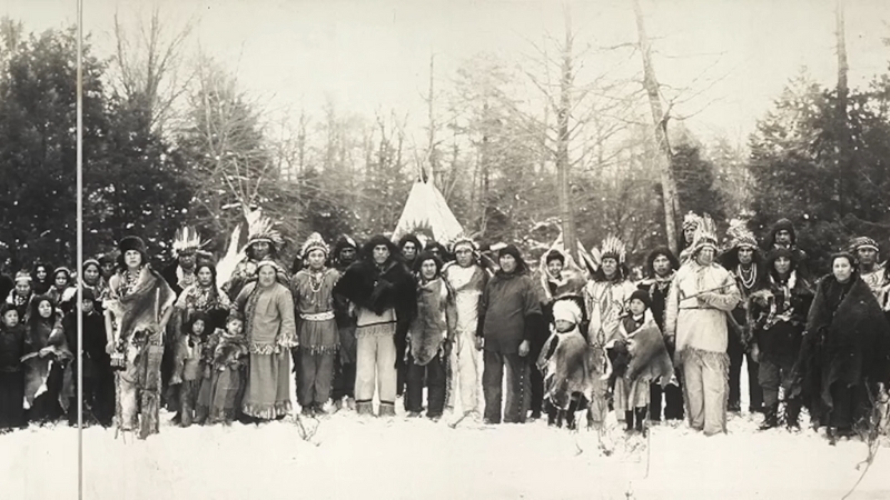 A group photo of the Iroquois people in traditional clothing during winter
