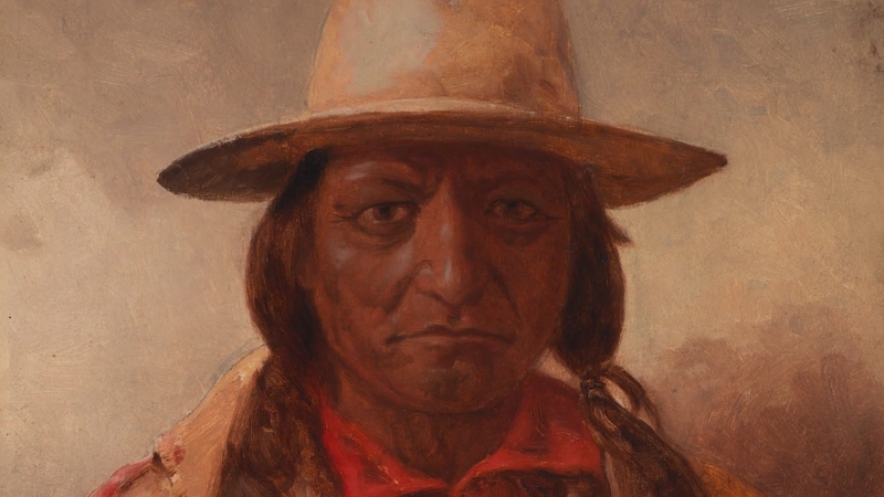 Portrait of Sitting Bull wearing a hat and red shirt