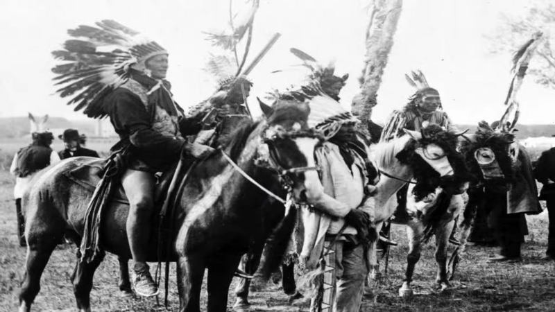 Lakota warriors on horseback wearing traditional headdresses during the fight for the Black Hills